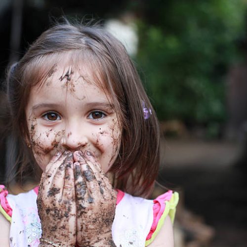 Little Mud Girl Hiding her mouth